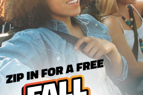 Two women smiling in a car. Text reads "Zip in for a free fall shine-up in Arlington!"